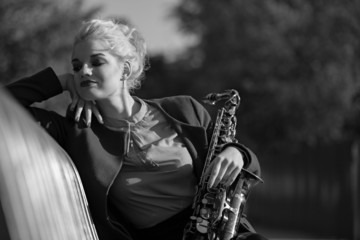 girl with saxofon on street