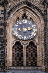 Ancient clock on the facade of the main entrance to the St. Vitu