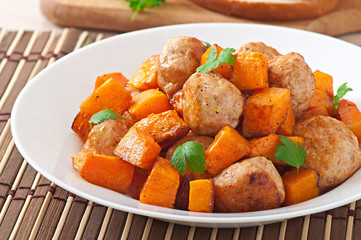 Chicken meatballs with a garnish cooked of baked pumpkin