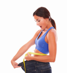 Sporty young lady measuring weight loss