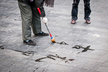 man practising chinese calligraphy, Temple of Heaven in Beijing