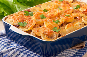 Potato casserole with meat and mushrooms with cheese crust