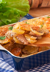 Potato casserole with meat and mushrooms with cheese crust