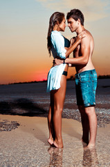 Couple on the beach at sunset