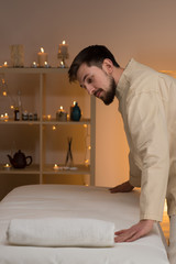 Masseur at spa or beauty salon working