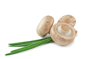 Three raw mushrooms and onion leaves