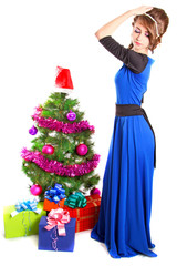 Portrait of a beautiful young woman near the Christmas tree
