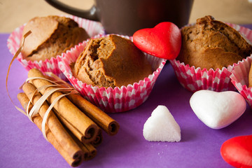 muffin and cinnamon with hearts on red background