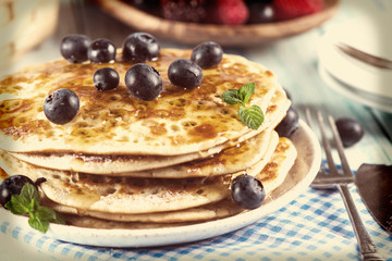 Homemade golden pancake with fresh berrys and mint