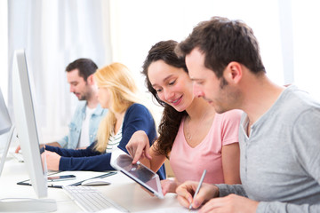 Young attractive people working together at the office