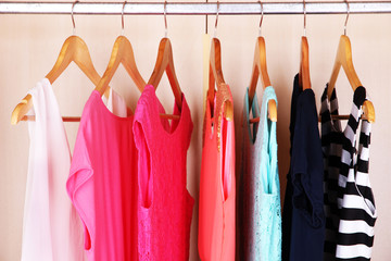 Female clothes on hangers in wardrobe