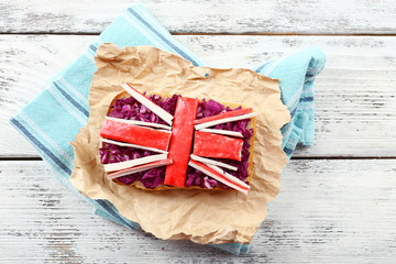 Sandwich with flag of Great Britain on table close-up