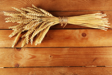 Spikelets of wheat on wooden background