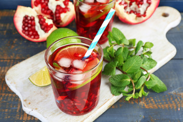 Pomegranate drink in glasses with slices of lime and mint