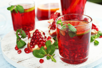 Pomegranate drink in glasses with mint and slices of orange