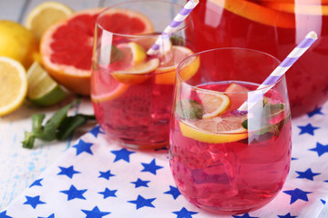 Pink lemonade in glasses and pitcher on table close-up