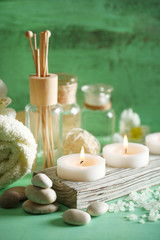 Composition of spa treatment, candles in bowl with water