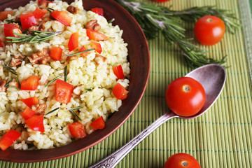 Rice with walnuts and cherry tomatoes in plate