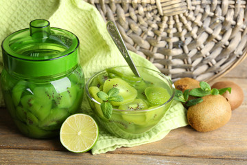 Tasty kiwi jam in glass bowl and jar