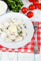 Meat dumplings with sauce on plate on table close-up