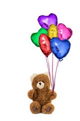 Teddy bear holding many colorful balloons