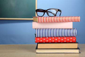 Stack of books with glasses