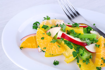 Waldorf salad with orange on plate on table close up