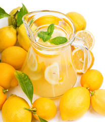 emon juice in a jug and fruit with leaves