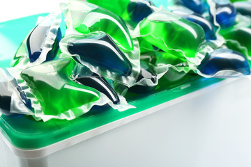 Gel capsules with laundry detergent in box close up