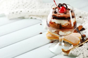 Foto op Plexiglas Tasty tiramisu dessert in glass, on wooden background © Africa Studio