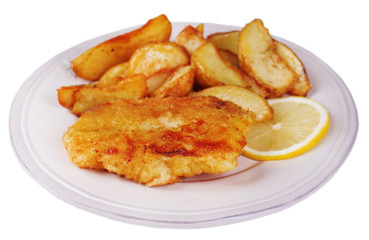 Breaded fried fish fillet and potatoes with sliced lemon