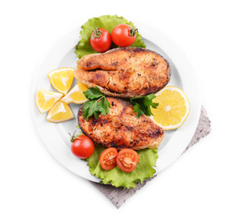 Tasty baked fish on plate isolated on white