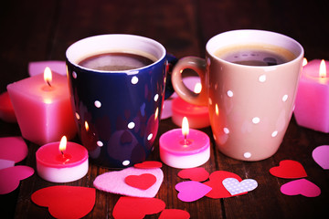 Two cups on table with candles and decor close-up