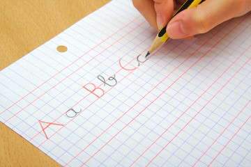 Closeup on the hands of a child doing writing activity as part