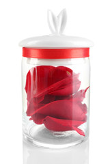 Rose petals in glass jar isolated on white