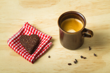Shot of espresso with healthy chia seed chocolate heart cookie