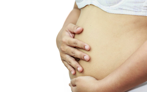 pregnant woman holding her belly with hands