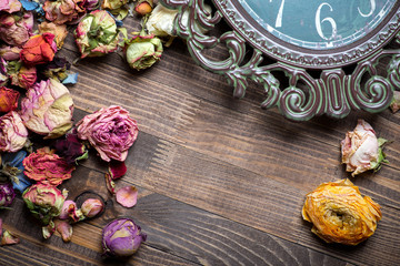  rose petals and dried flowers on old wooden plates.