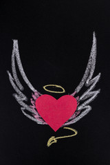paper heart with pictured chalk wings on black background