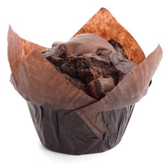 Chocolate chip muffin in brown wax paper.