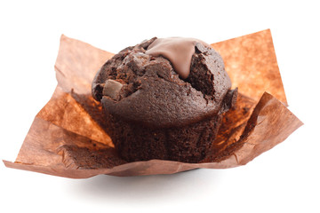 Chocolate chip muffin in brown wax paper. Unwrapped.