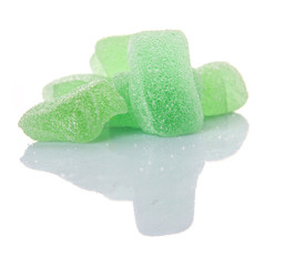 Light green colored sugar jelly candy over white background