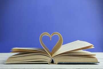 book of love with a heart on a blue background