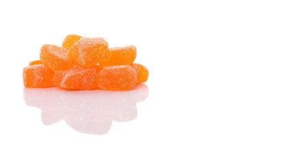 Orange colored sugar jelly candy over white background