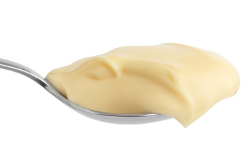 Detail of mayonnaise on stainless steel spoon. Isolated.
