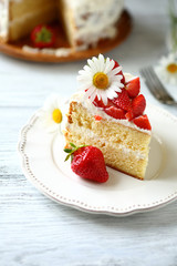 Slice of cake with strawberries on a white plate