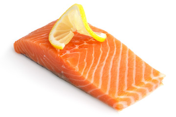 Raw salmon fillet on white. Lemon slice.