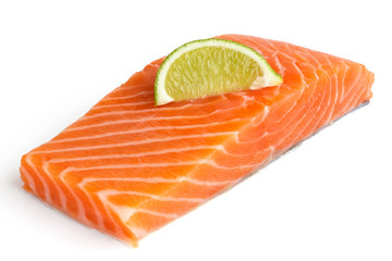 Raw salmon fillet on white. Lime slice.