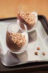 Dessert with creme, chocolate and puffed wheat.