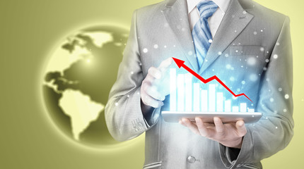 business man using tablet computer to work with financial data